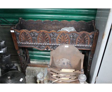 AN OAK PLANTER with acanthus leaf carved decoration, tin lining and standing on turned legs united by an 'H' stretcher 90cm w