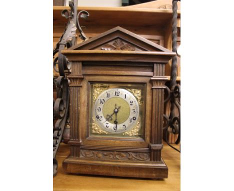 A GERMAN WALNUT MANTLE CLOCK the case of architectural portico form and the silver chapter ring with Arabic numerals, the mov