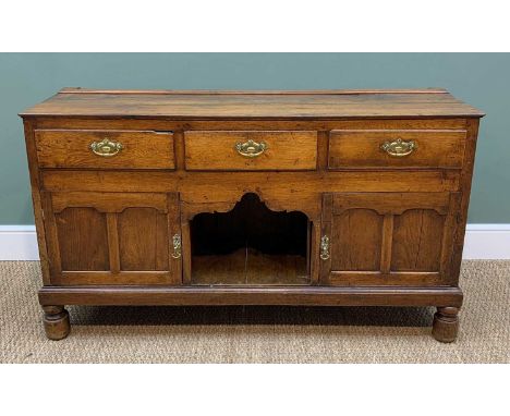 LATE GEORGE III OAK DRESSER BASE, plank top above three frieze drawers, cupboards and dog kennel base, later turned feet, 82h