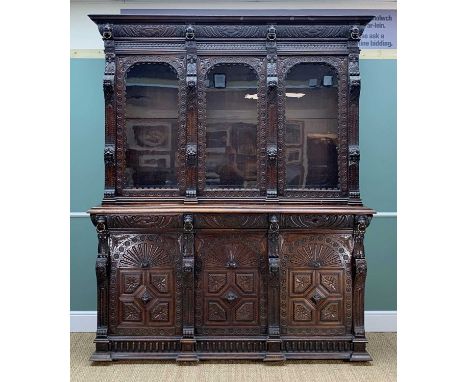 LARGE RENAISSANCE REVIVAL CARVED OAK CABINET, with lion mask and metal ring cornice, three arched and glazed doors between sc