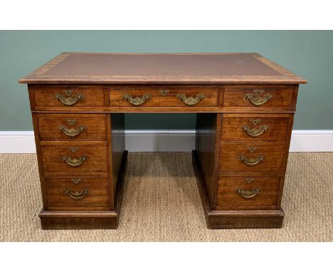ANTIQUE KNEEHOLE WRITING DESK having a bank of nine drawers, bearing ornate brass handles and with leather insert to top, 122