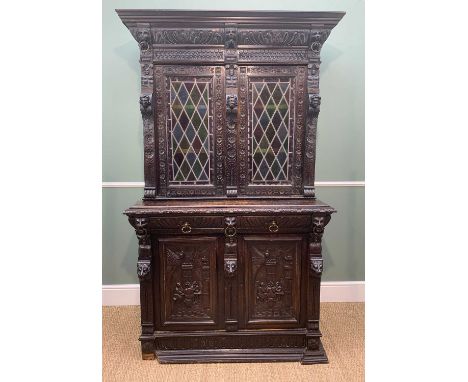 19TH CENTURY FLEMISH CARVED OAK CABINET, with later leaded and glazed panels to the carved doors above two frieze drawers and