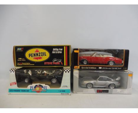 Four large scale die-cast replica classic vehicles to include a 1973 Firebird Trans-am, a 1971 Chevrolet etc. 