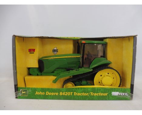 An Ertl 1/16th scale John Deere 8420T tractor.