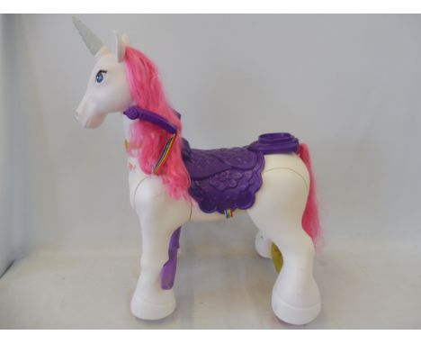 A large scale battery operated unicorn on wheels.