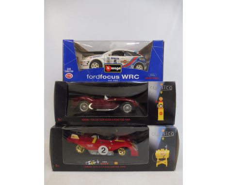 Three 1/18 scale models: a Ford Focus, Mario Andretti 1972 Ferrari and a 1958 Ferrari. 