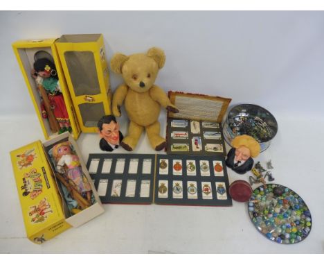 A selection of period toys to include Pelham Puppets (x2), a straw-filled teddy bear, Spitting Images (circa 1984), lead figu