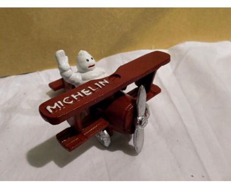 Cast iron Michellin Man in a plane H: 80 mm. UK P&amp;P Group 1 (£16+VAT for the first lot and £2+VAT for subsequent lots) 