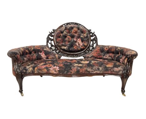 Victorian mahogany framed serpentine sofa, double curved scroll ends, upholstered in rose fabric, terminating in ceramic cast