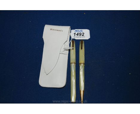 A leather cased Waterman's propelling Pencil and a thermometer.