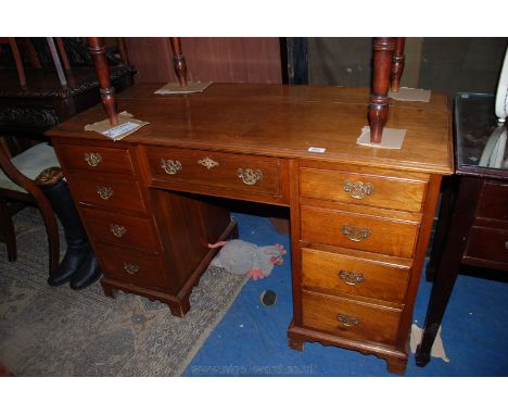 A late 19th c. Mahogany kneehole Desk, having moulded edge rectangular top, over central wide frieze drawer, flanked either s