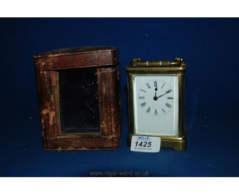 A Brass French Carriage Clock with key.  R & Co., Paris.  3 1/2'' tall, in original case.