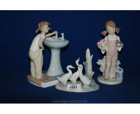 A Lladro figure of a small girl at a washbasin, another Lladro figure of young girl with bunch of flowers and a Nao figure of