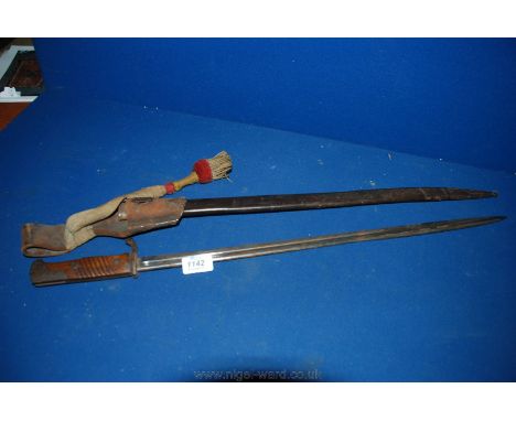 A wooden handled steel WWI Bayonet in leather scabbard with reinforced metal tip, with leather belt holder and tassel