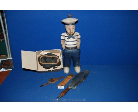 A quantity of miscellanea including a wooden sailor, a WWII Gas Mask in original box, an ornate Trowel style Tool with wooden