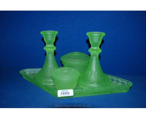 An art deco Uranium glass Dressing Table set, in frosted green, comprising two candlesticks, two lidded bowls and diamond sha