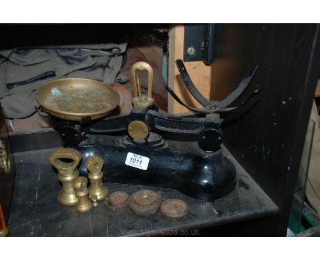 A Boots kitchen scales and various weights.