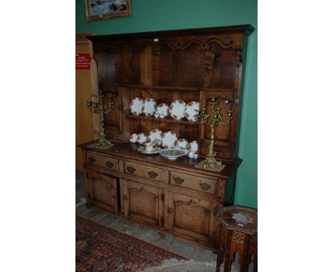 A Superb reproduction Oak Dresser being traditionally constructed, having moulded cornice with castellated detail over fret-c