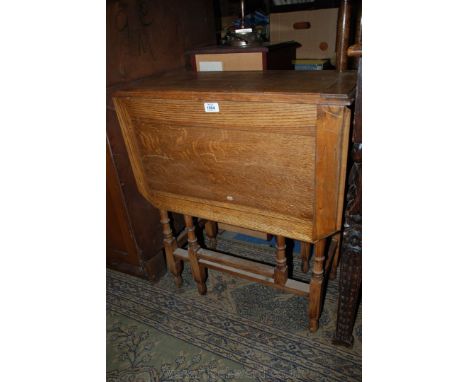 A 1940's light Oak dropleaf occasional Table, having rectangular cleated top with similar cut corner leaves, standing on slen