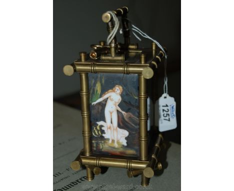 A French Carriage Clock decorated with hand painted enamel panels of nude figures in various poses, complete with key