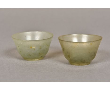 A pair of small jade tea bowls
Each of flared form with a circular foot rim.  Each 5.25 cm diameter.  (2) CONDITION REPORTS: 