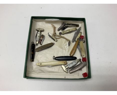 A box containing vintage miniature pen knives.