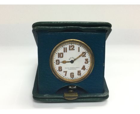 A vintage 8 day travelling clock. (B)