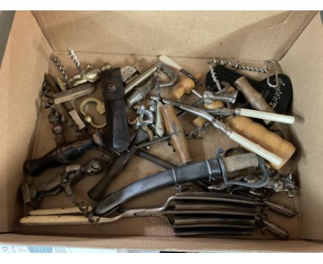 A box containing vintage pen knifes and cork screws.