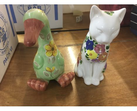 A box of large ceramic animal figures and other items including some glassware.