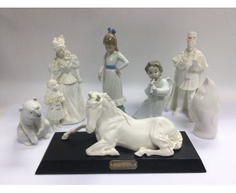 Seven ceramic figures comprising Lladro, Nao and others. Shipping category D.