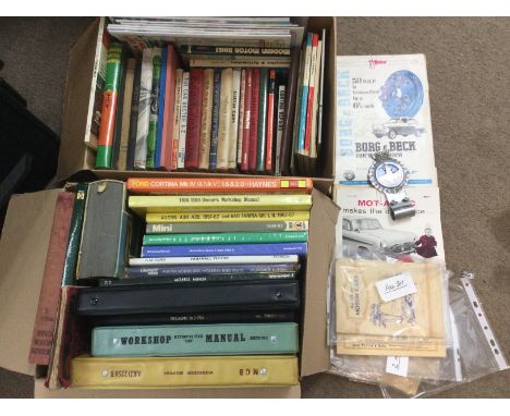 Two boxes of automobile books and manuals plus a St Christopher car mascot and sime cigarette card albums. Shipping category 