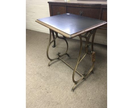 A Victorian occasional table with shaped cast iron supports. 55x45cm