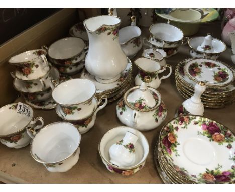 A Royal Albert country rose Dinner/ tea including coffee pot tea pot serving plates bowls cups and saucers.