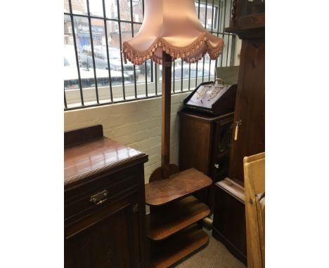 A WLnut Art Deco design free standing lamp with open shelfs.