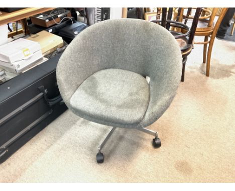 A vintage Heals Polytropos swivel chair with a chrome base