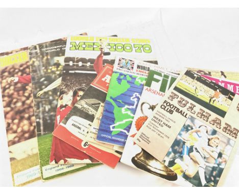 A collection of vintage football programmes and sticker albums including a 1966 World Cup Programme, various West Ham program