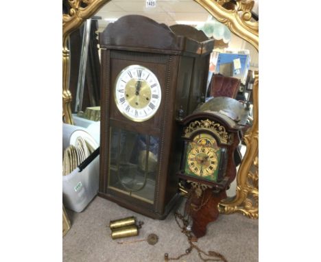 A moon phase dial wall clock and a mahogany cased wall clock (2). Shipping category D.