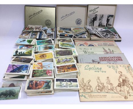 A collection of cigarette cards and vintage postcards including some silks. Shipping category C.- NO RESERVE