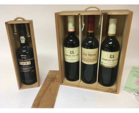 A Vintage bottle of Portuguese Port 1983 in a wood case and three Vintage bottles of Rioja 1988 1994 and 2001 in a wooden cas