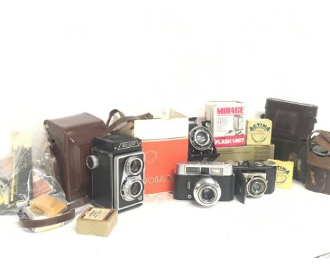 A collection of vintage cameras including Rollop, Voigtlander Vito CL, Kodak Compur,