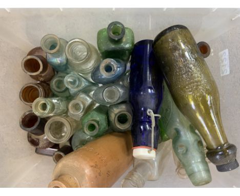 A box of vintage glass bottles including medicine bottles.