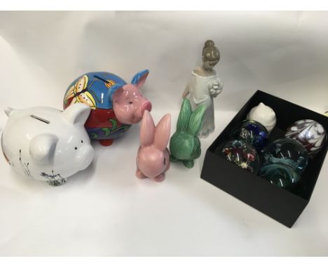 A collection of paper weights, a Nao figure, two ceramic piggy money boxes, slyvac rabbits.