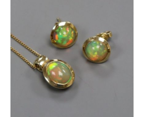 A modern 14ct gold and opal pendant necklace and a pair of matching ear studs.