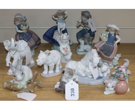 A collection of ten Lladro figures and one Nao figure, including three elephants with flowers, kitten with flowers, kitten wi