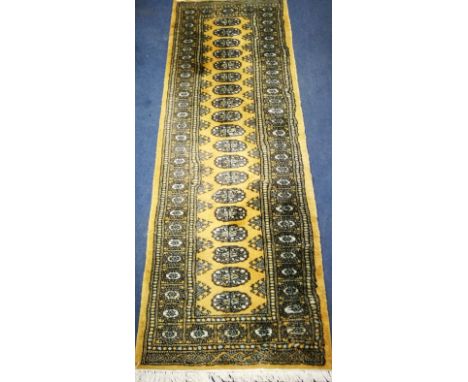 A modern Bokhara fawn ground runner 178 x 64cm