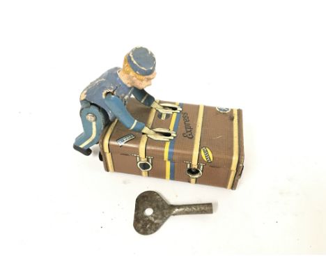 A Vintage Gescha Express Tin Wind Up Button Boy. With Key.