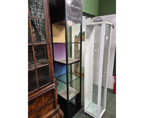 A Georg Jensen show room blackened metal display cabinet with four shelves below electric lighting.   W 40 x D 40 x H 216cms