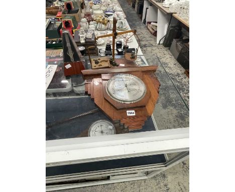 An aneroid barometer, a metronome and a set of scales with weights