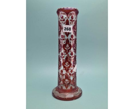 A Bohemian ruby overlay glass cylindrical vase with flower stems in geometrical panels.   H 31 cms. together with a pair of p