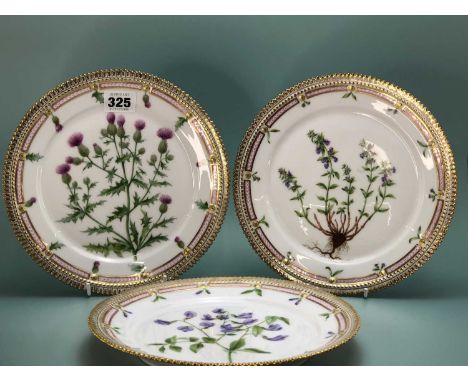 Eight Royal Copenhagen plates decorated with named botanical specimens within gilt serrated rims. 22cms diameter